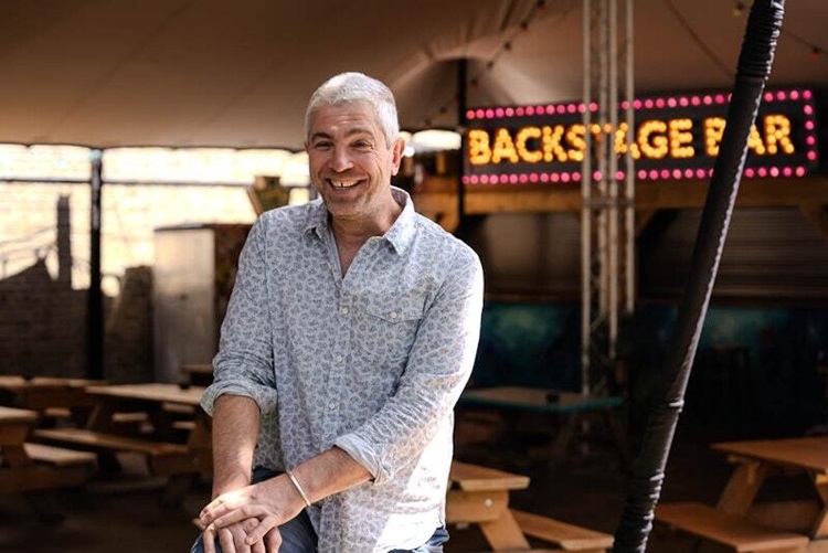 Owner of Fox and Firking standing at his bar.