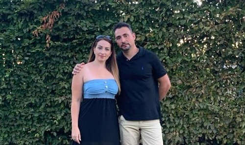 Couple standing in garden.