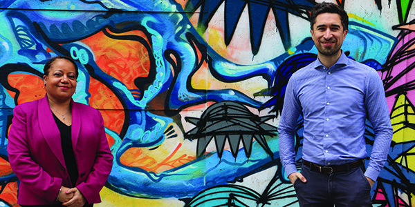 Deputy Mayor Brenda Dacres stands next to Damien Egan, Mayor of Lewisham. They are one metre apart and in front of a colourful painted wall.