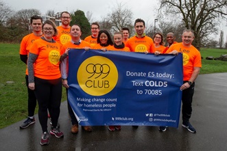 Marathon runners in park with 999 sign