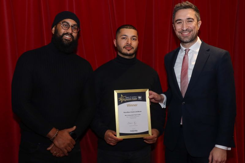 The two co-owners of Marvellous Greens and Beans standing with the Mayor, holding their winners certificate